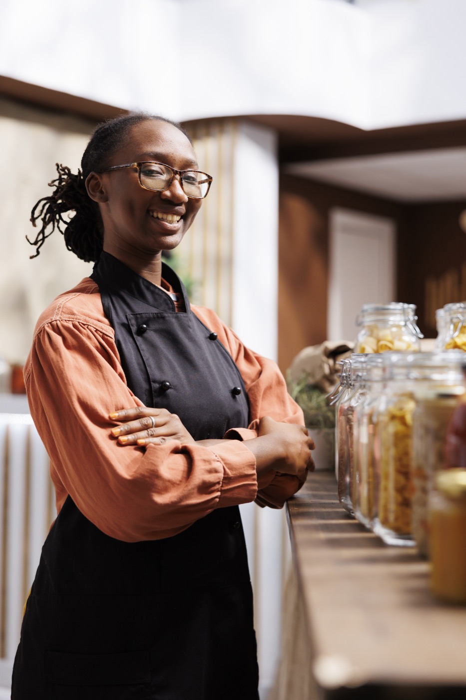 A shopkeeper behind her counter