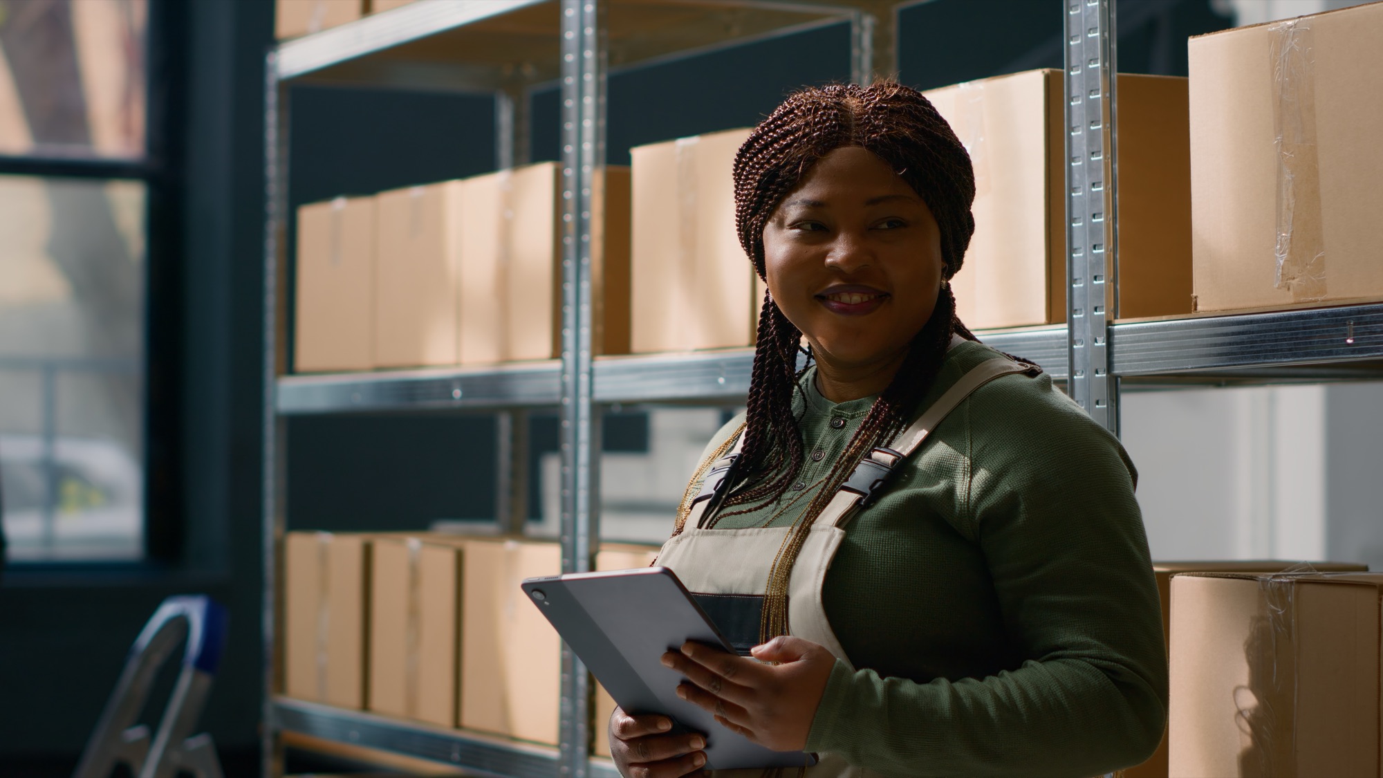 A supervisor checking stock on a tablet